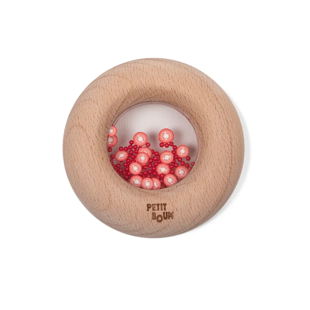 Sonajero sensorial donut tomates para estimular el oído y la vista, ideal para primeras exploraciones. Petit Boum en Mimú
